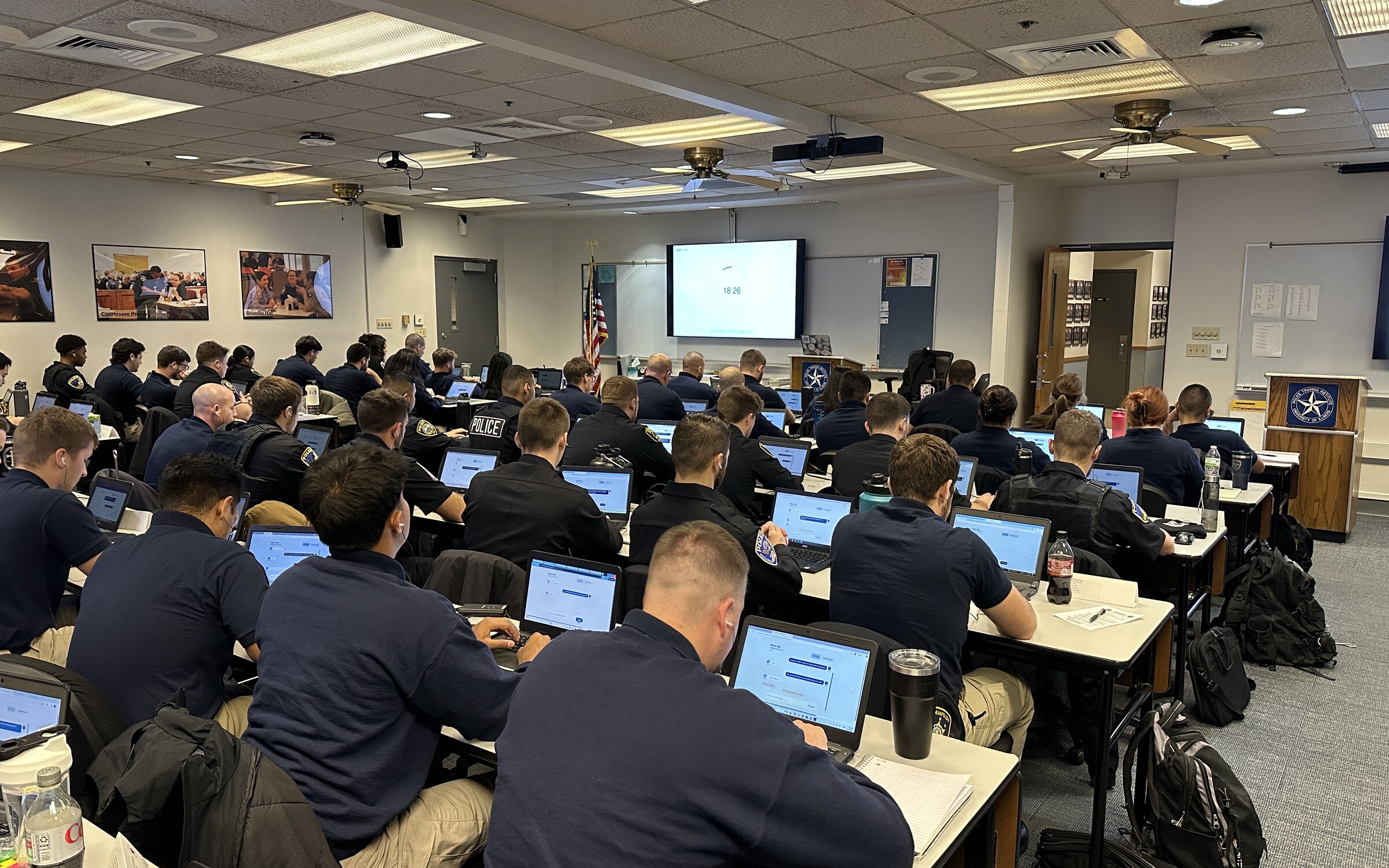 Police recruits using Voysses on laptops in a Police Training Institute classroom